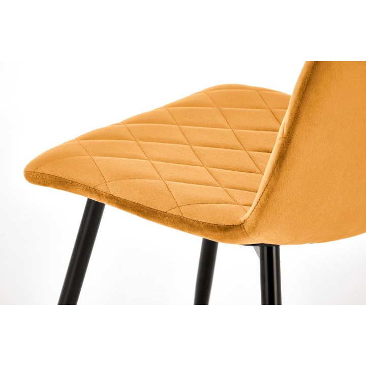 Musztardowe tapicerowane krzesło do jadalni z czarnymi nogami